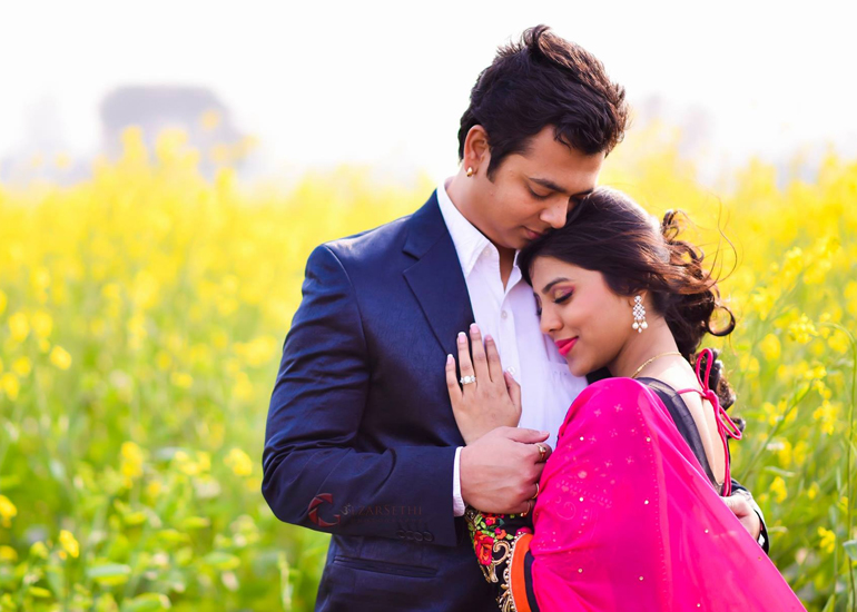 Couple sitting together in a field